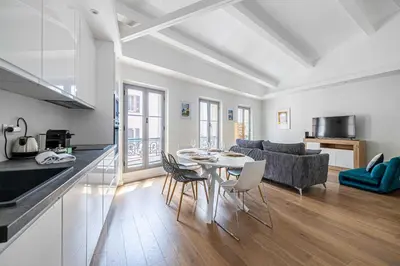 a kitchen and living room with a table and chairs at Charming apartment - Near the Old Port and Suquet in Cannes