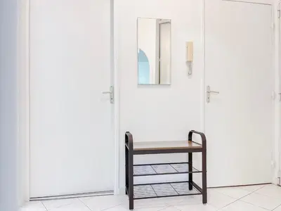 a table and a chair in front of a door at Le Cannes Mélodie - Terrasse in Cannes
