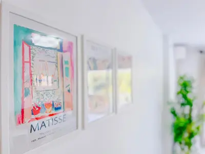 a row of framed pictures on a wall at Le Cannes Mélodie - Terrasse in Cannes