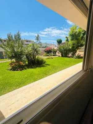 a window with a view of a yard at Charmant Studio à 5 minutes des plages in Cannes