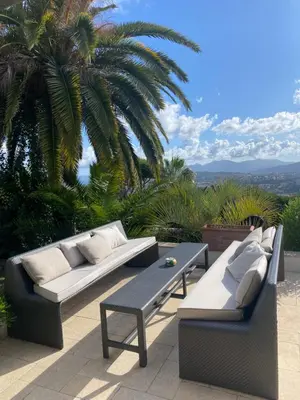 two couches and a coffee table on a patio at La Pastourelle in Le Cannet
