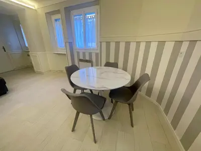 a dining room with a glass table and chairs at La Brise by Connexion in Cannes