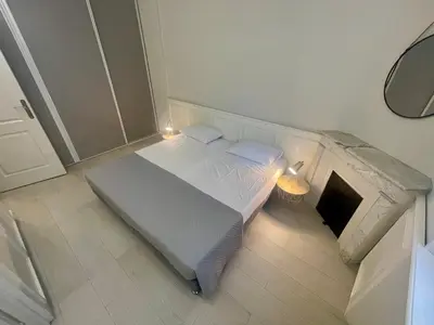 a small bedroom with a bed with lights on it at La Brise by Connexion in Cannes