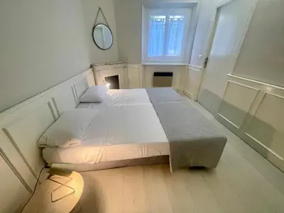 a bedroom with a bed and a mirror on the wall at La Brise by Connexion in Cannes