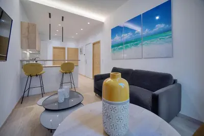 a living room with a couch and a table at TOP renovated 1 bedroom near Palais 2P1 by RIVAEVENT in Cannes