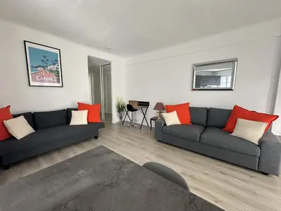 a living room with two couches and a table at Studio confortable proche mer deb1890 in Cannes