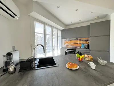 a kitchen with a counter with a bowl of fruit on it at Studio confortable proche mer deb1890 in Cannes