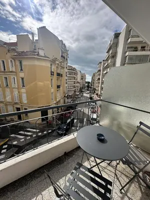 a balcony with a table and chairs on a balcony at Studio confortable proche mer deb1890 in Cannes