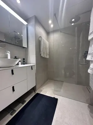a bathroom with a glass shower and a sink at Appartement centre ville 7 Lecerf in Cannes