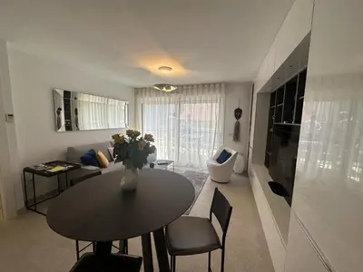 a living room with a table and a couch at Appartement centre ville 7 Lecerf in Cannes