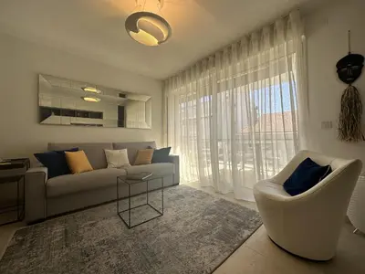 a living room with a couch and a chair at Appartement centre ville 7 Lecerf in Cannes
