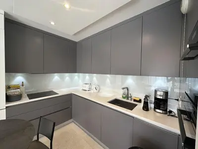 a kitchen with gray cabinets and a counter top at Appartement centre ville 7 Lecerf in Cannes