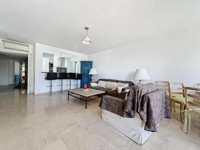 a living room with a couch and a table at 78m2 Terrasse vue mer à 50m de la Croisette in Cannes