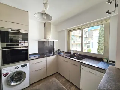 a kitchen with a washing machine and a window at 78m2 Terrasse vue mer à 50m de la Croisette in Cannes