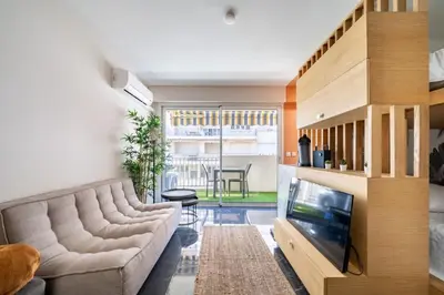 a living room with a couch and a television at Sublime studio in the center of Cannes in Cannes