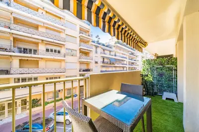 an apartment balcony with a table and chairs at Sublime studio in the center of Cannes in Cannes