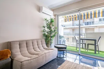 a living room with a couch and a large window at Sublime studio in the center of Cannes in Cannes