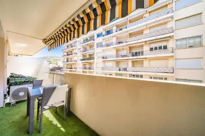 a balcony of a building with a table and chairs at Sublime studio in the center of Cannes in Cannes
