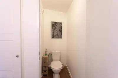 a bathroom with a white toilet in a room at Cosy Escape YourHostHelper in Cannes