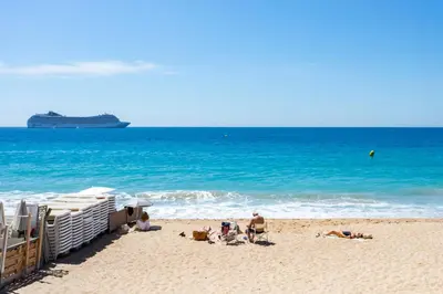 a group of people on a beach with a cruise ship at Cosy Escape YourHostHelper in Cannes