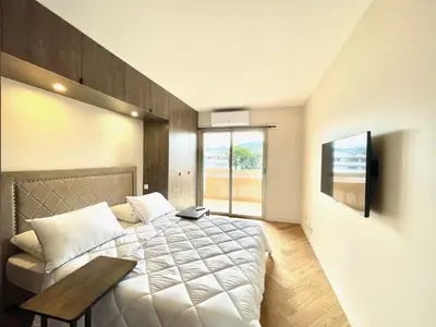 a bedroom with a bed and a table in it at Astoria luxury apartment- 3 bathrooms in Cannes