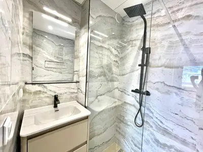 a bathroom with a sink and a shower at Astoria luxury apartment- 3 bathrooms in Cannes