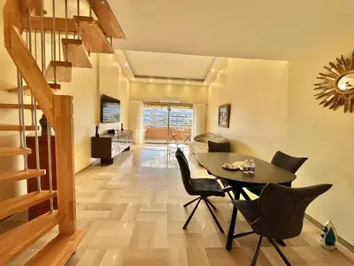 a dining room with a table and chairs at Astoria luxury apartment- 3 bathrooms in Cannes
