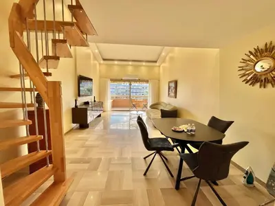 a dining room with a table and chairs at Astoria luxury apartment- 3 bathrooms in Cannes