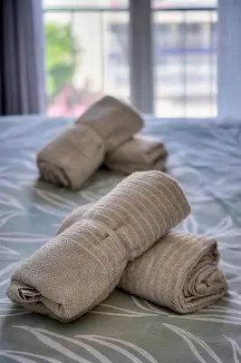 two towels sitting on top of a bed at Le Eve- 350M mer- 600 Palais-VCA in Cannes