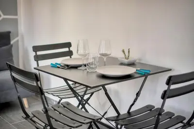 a table with chairs and plates and wine glasses at Le Eve- 350M mer- 600 Palais-VCA in Cannes