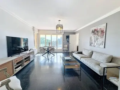 a living room with a couch and a flat screen tv at MIA2 - 3 pièces avec terrasse in Cannes