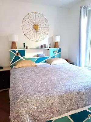 a bedroom with a large bed and a large window at Charmant 3pièces près de Cannes in Le Cannet