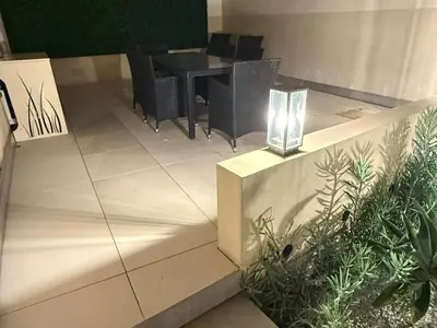 a dining area with a table and chairs and plants at Cannes Garden Suquet, Terrasse & Garage in Cannes