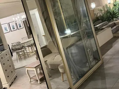 a living room with a couch and a mirror at Cannes Garden Suquet, Terrasse & Garage in Cannes