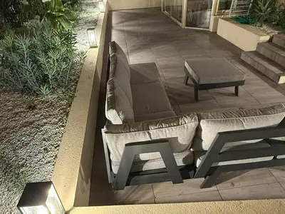 a couch and a table on a patio at Cannes Garden Suquet, Terrasse & Garage in Cannes