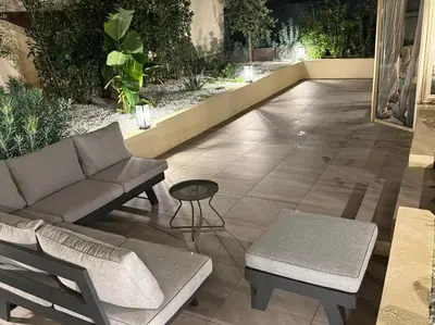 a patio with a couch and chairs and a table at Cannes Garden Suquet, Terrasse & Garage in Cannes