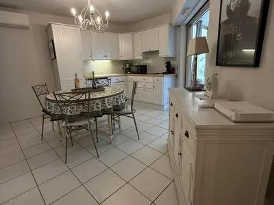 a kitchen with a table with chairs and a dining room at Cannes Garden Suquet, Terrasse & Garage in Cannes