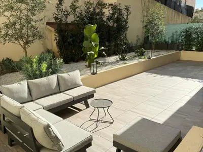 a patio with a couch and a table at Cannes Garden Suquet, Terrasse & Garage in Cannes