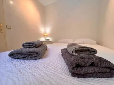 a bedroom with a bed with towels on it at Cannes Garden Suquet, Terrasse & Garage in Cannes