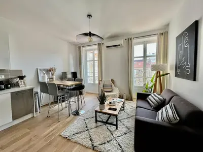 a living room with a couch and a table at Cannes banane, T2 centre ville, 400 m des plages in Cannes