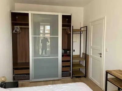 a room with a glass cabinet with a person in it at Cannes banane, T2 centre ville, 400 m des plages in Cannes
