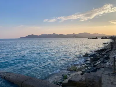 a large body of water with mountains in the background at Cannes Sea View, by Beach, Private Room in Shared 3-Bedroom Apartment, Private Bathroom & Balcony,, Chambre avec salle de bain privative & balcon, chez l'habitant in Cannes