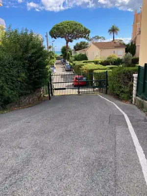 a driveway with a gate in front of a house at Cannes Sea View, by Beach, Private Room in Shared 3-Bedroom Apartment, Private Bathroom & Balcony,, Chambre avec salle de bain privative & balcon, chez l'habitant in Cannes