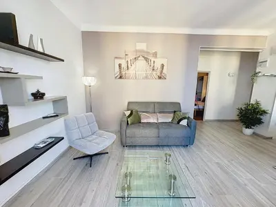 a living room with a couch and a chair at ROL2 - Beau 2 pièces avec balcon et vue mer latérale in Cannes