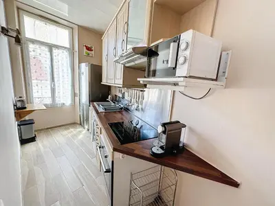 a kitchen with a counter top and a microwave at ROL2 - Beau 2 pièces avec balcon et vue mer latérale in Cannes