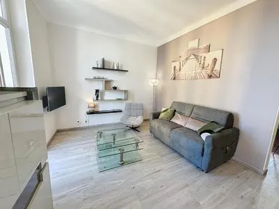 a living room with a couch and a glass table at ROL2 - Beau 2 pièces avec balcon et vue mer latérale in Cannes