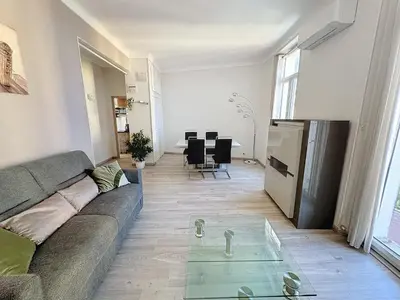 a living room with a couch and a glass table at ROL2 - Beau 2 pièces avec balcon et vue mer latérale in Cannes