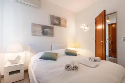 a bedroom with a white bed with towels on it at ARM1 - Beau 2 pièces avec terrasse d'angle in Cannes