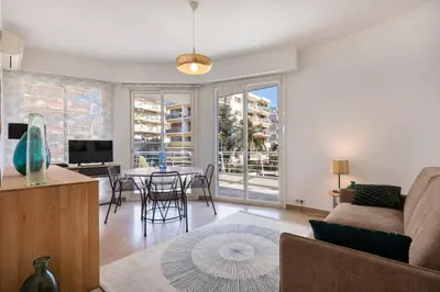 a living room with a couch and a table at ARM1 - Beau 2 pièces avec terrasse d'angle in Cannes
