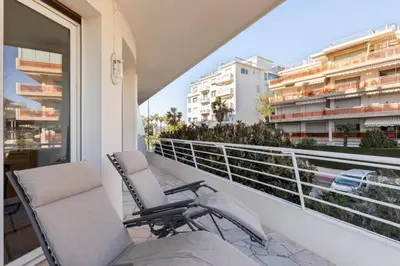 a pair of chairs sitting on a balcony at ARM1 - Beau 2 pièces avec terrasse d'angle in Cannes